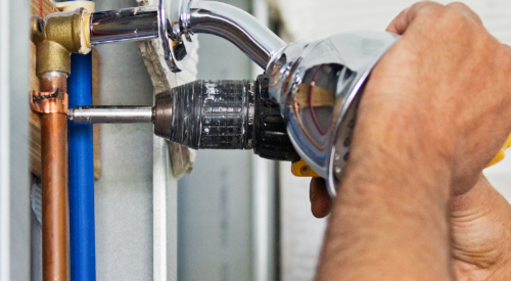 plumber inspecting sewer pipe in older Maryborough Queensland home
